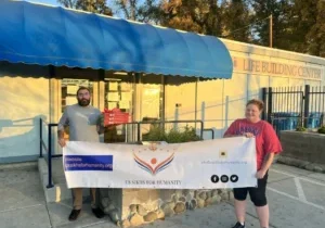 Volunteers holding US Sikhs for Humanity banner