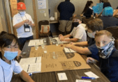 Children wearing masks working at table